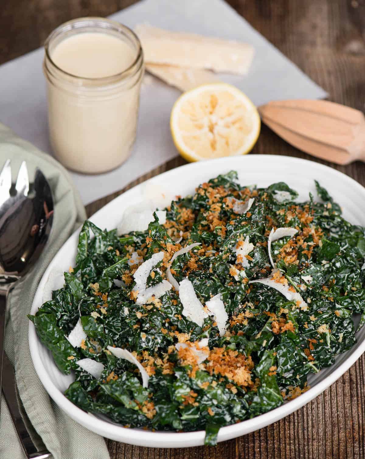 homemade kale ceasar salad with dressing in mason jar