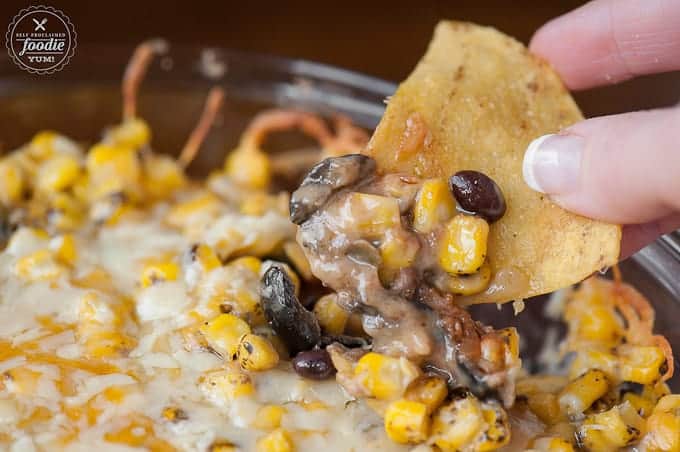 beans, corn, cheese, olives on a tortilla chip