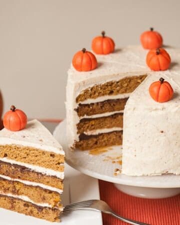 The best delicious fall dessert is this moist homemade Layered Pumpkin Cake with hazelnut buttercream, drunken chocolate ganache, and marzipan pumpkins!