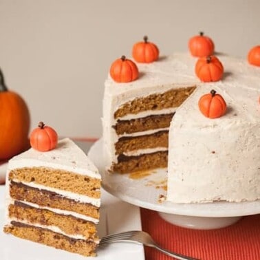 The best delicious fall dessert is this moist homemade Layered Pumpkin Cake with hazelnut buttercream, drunken chocolate ganache, and marzipan pumpkins!
