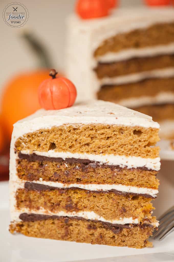 sliced layered pumpkin cake showing chocolate ganache and buttercream frosting