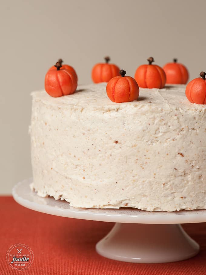  frosted layered pumpkin cake covered with marzipan pumpkins