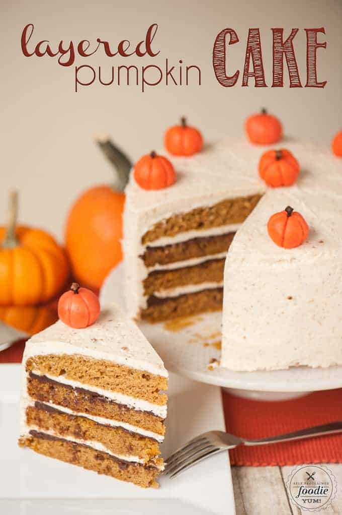 Thefrosted layered pumpkin cake being sliced 