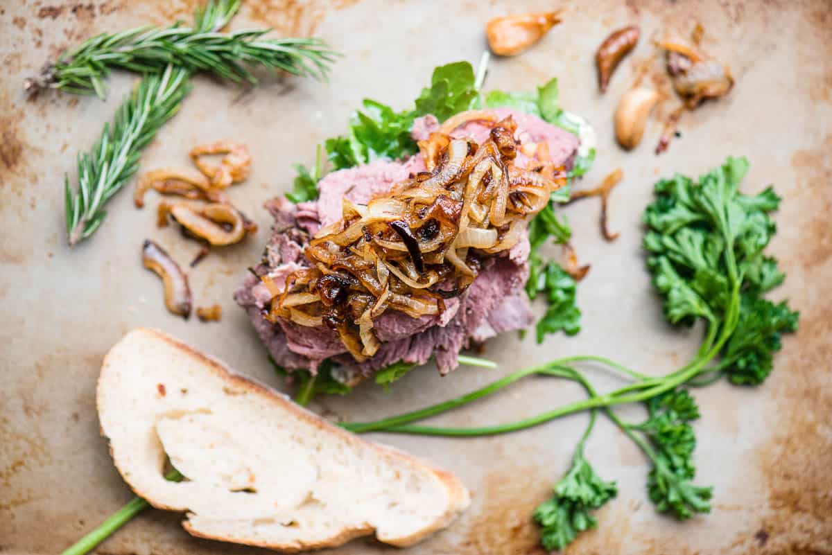 grilled onions over shaved prime rib for sandwich