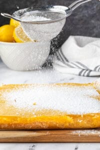 dusting lemon bars with powdered sugar