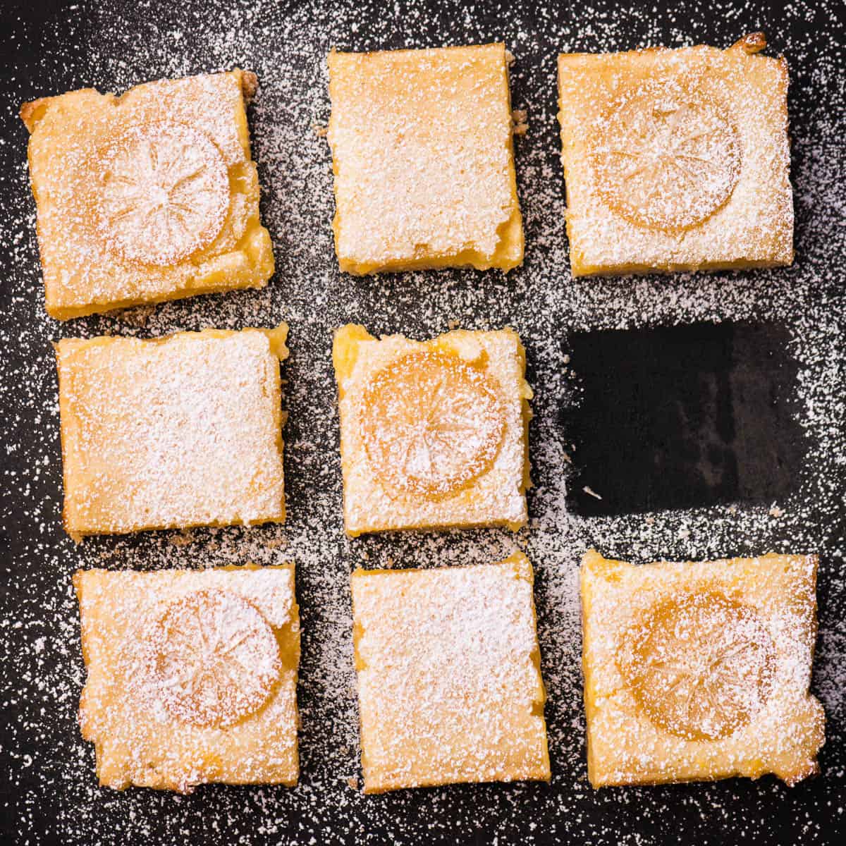 cut lemon squares on black background