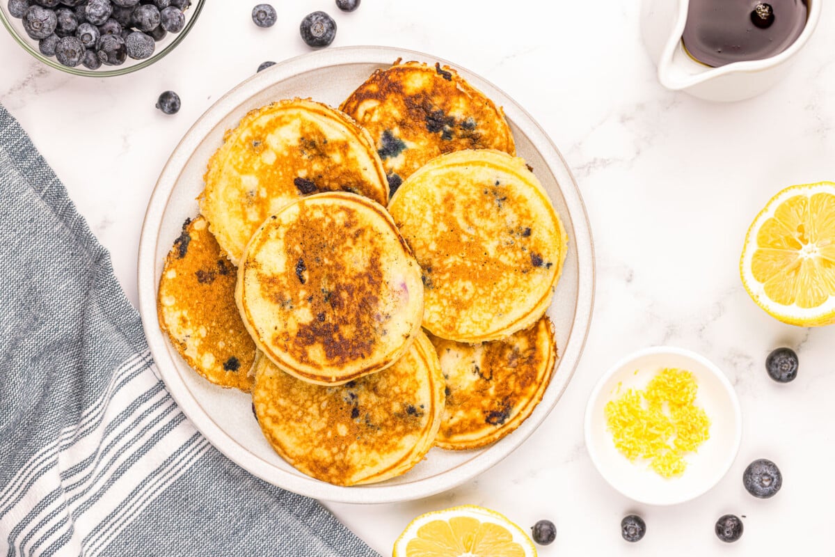 lemon blueberry pancakes on plate with lemon zest.