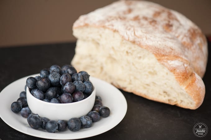 blueberries and bread on a black surface