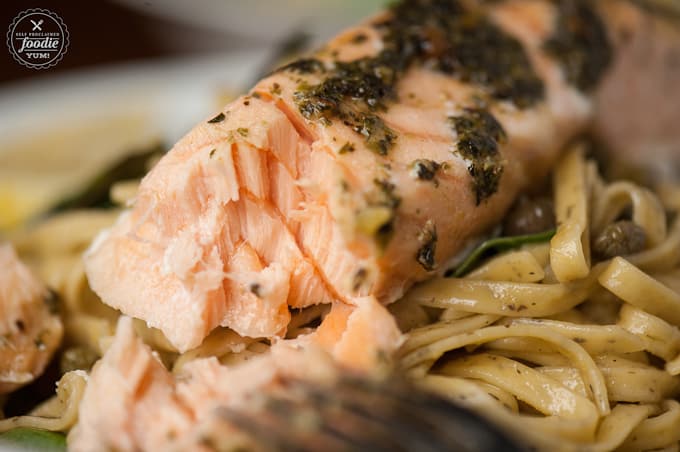 a lose up of salmon on pasta