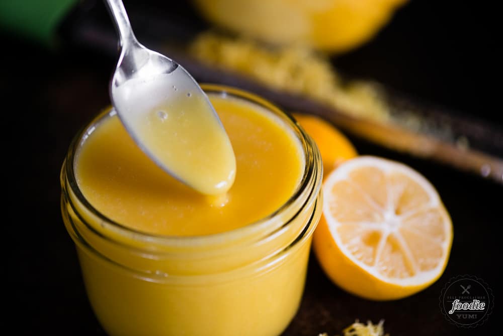 spoon dipping in lemon curd made with egg yolks