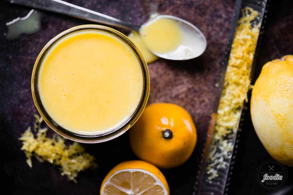 homemade lemon curd in glass dish with zested meyer lemon