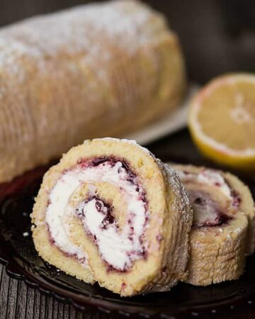 Lemon Lingonberry Jam Cake Roll is a lovely and delicious dessert consisting of scratch made lemon cake, sweet lemon cream, and tart lingonberry preserves.
