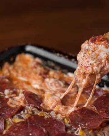 A close up of a scoop of pizza dip