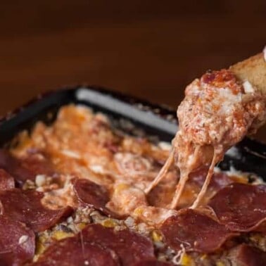 A close up of a scoop of pizza dip