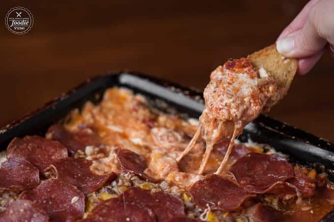 A close up of a scoop of pizza dip