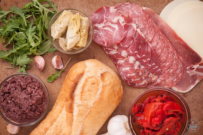 italian sandwich ingredients like meat, olive tapanade, bread