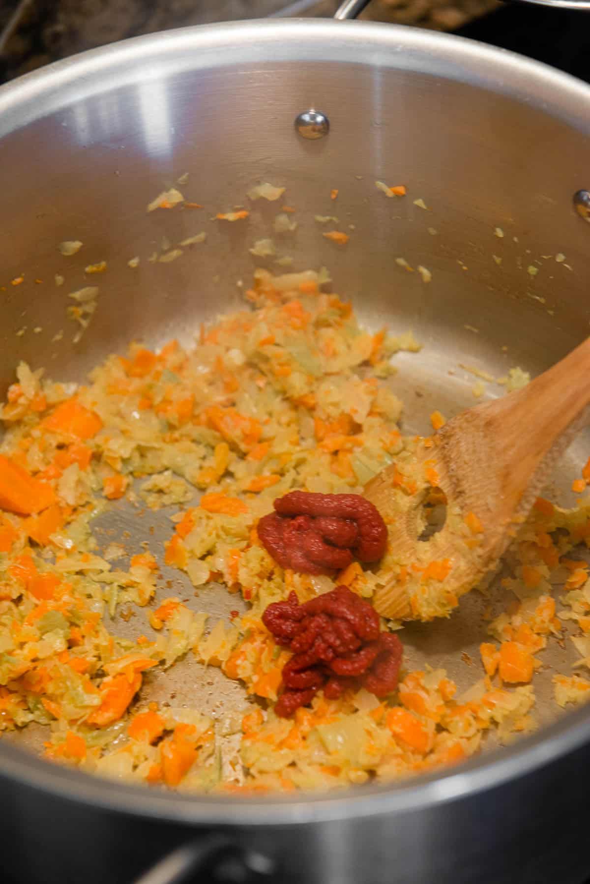 adding tomato paste to mirepoix