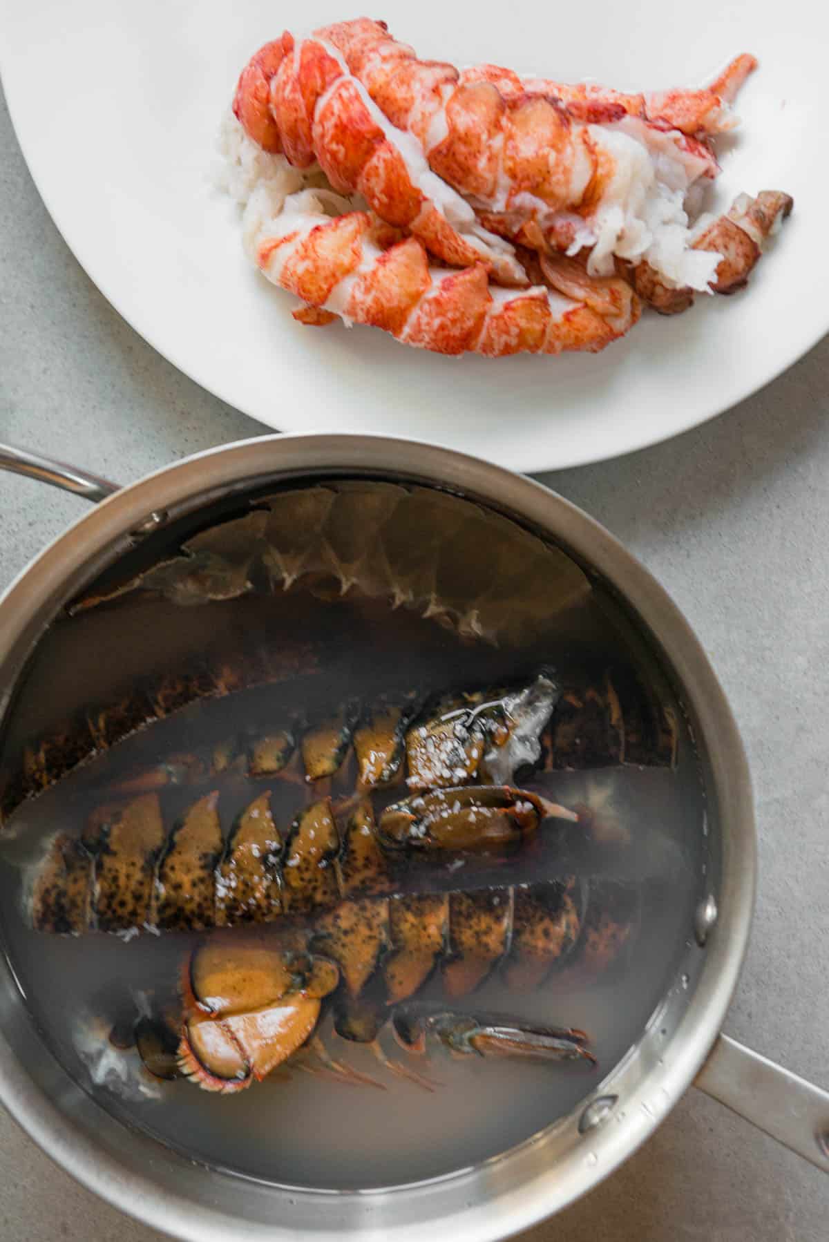 lobster tail shells in water with meat on plate