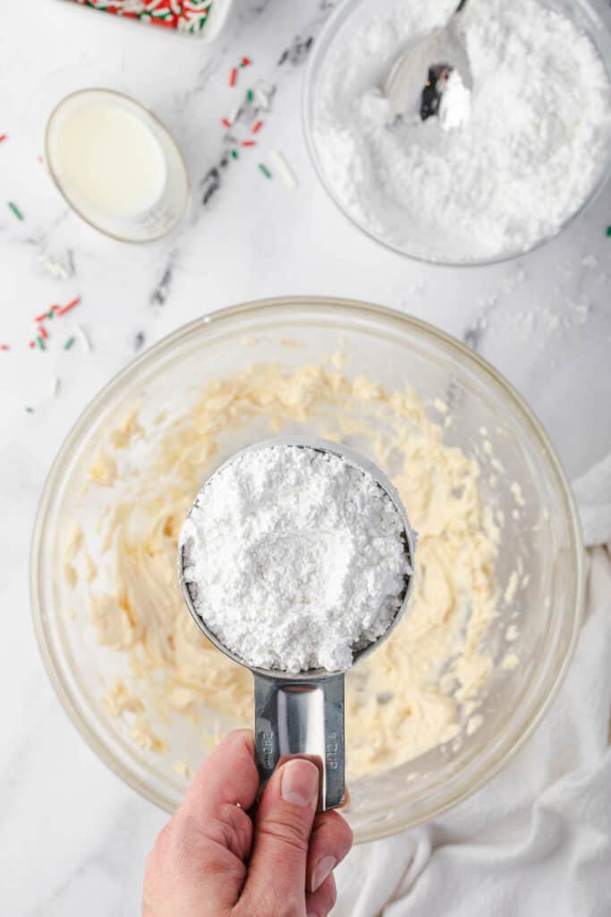 adding confectioners' sugar to butter