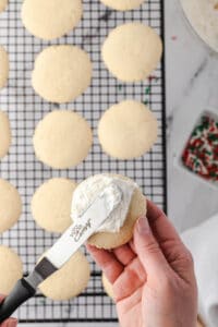 spreading frosting onto soft sugar cookie