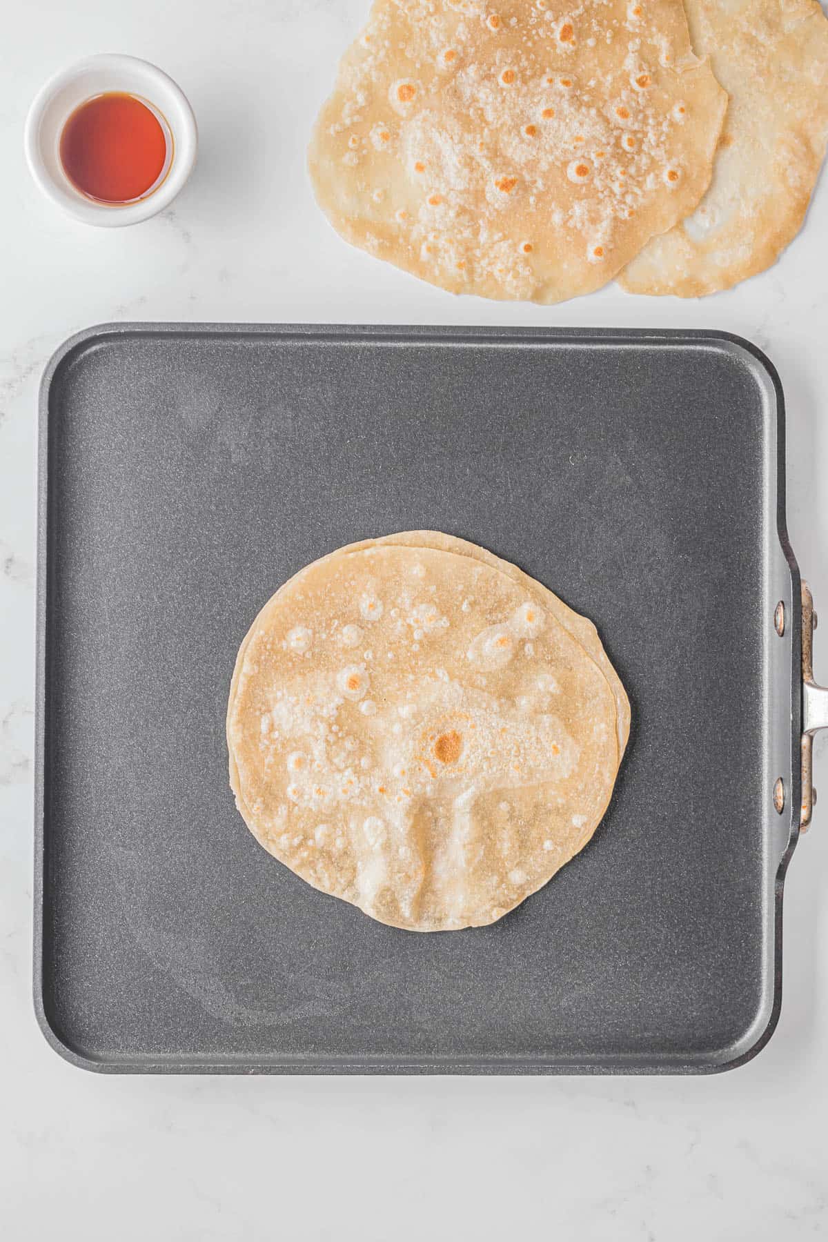 Mandarin pancakes on griddle.