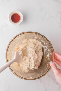 stirring flour and water to make Mandarin pancakes.