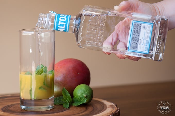 tequila being poured into a glass