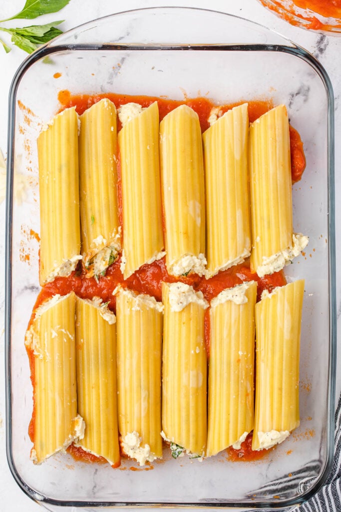 Cheese stuffed manicotti tubes in pan