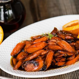Maple Orange Roasted Carrots, with pure maple syrup, orange, and herbs, are an easy carrot side dish that is perfect for any dinner or holiday feast.