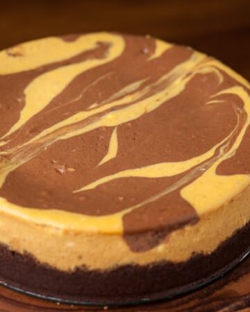 This homemade Marbled Chocolate Pumpkin Cheesecake made with a chocolate graham cracker crust and pumpkin puree is the perfect fall or Thanksgiving dessert!
