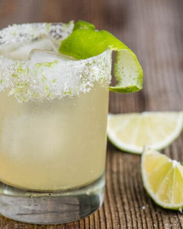 classic homemade margarita on the rocks with a salt rimmed glass and lime garnish