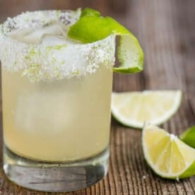 classic homemade margarita on the rocks with a salt rimmed glass and lime garnish