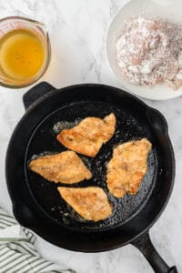 pan frying flour-coated chicken breasts.