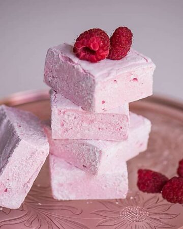 Homemade Raspberry Marshmallows, made with fresh raspberry puree, are surprisingly easy to make and are a fun summer dessert your family will love!