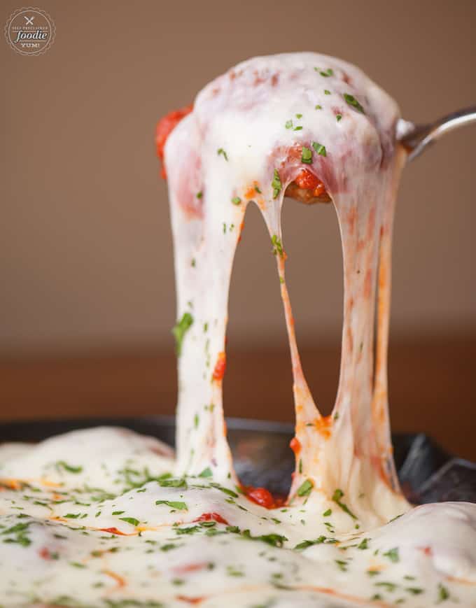 A close up of a scoop of meatball parmesan