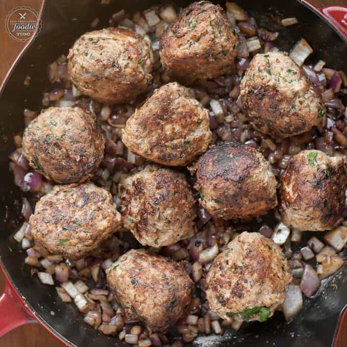 A pan of meatballs with onions