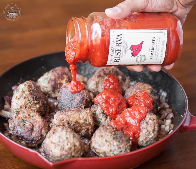 pasta sauce and meatballs in a pan