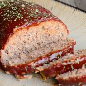 homemade sliced meatloaf with sauce.
