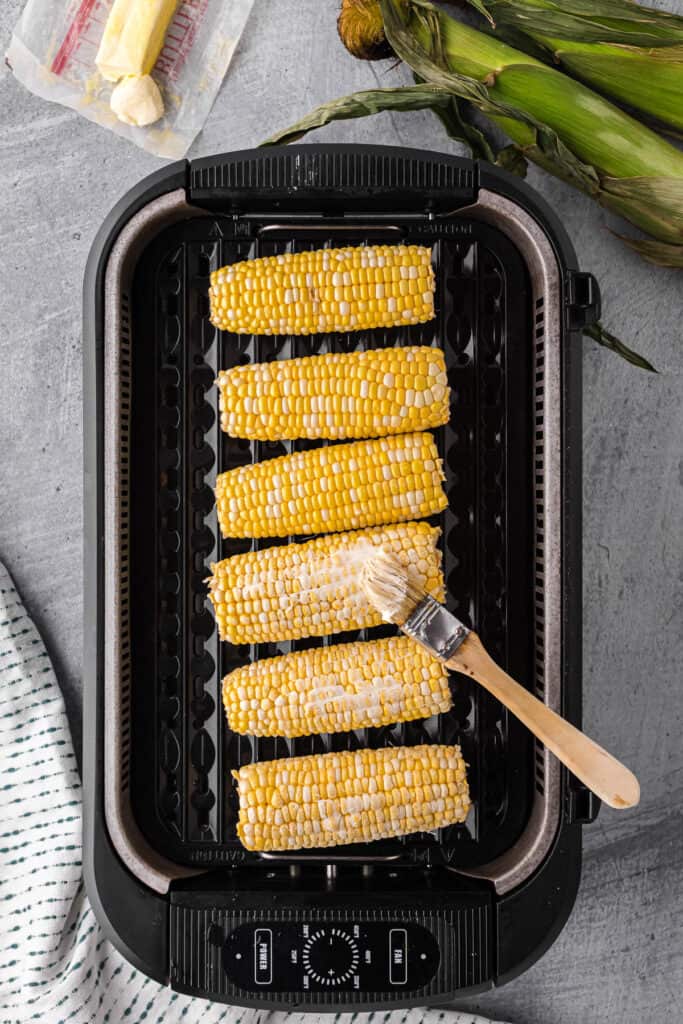 roasting fresh ears of corn in butter.