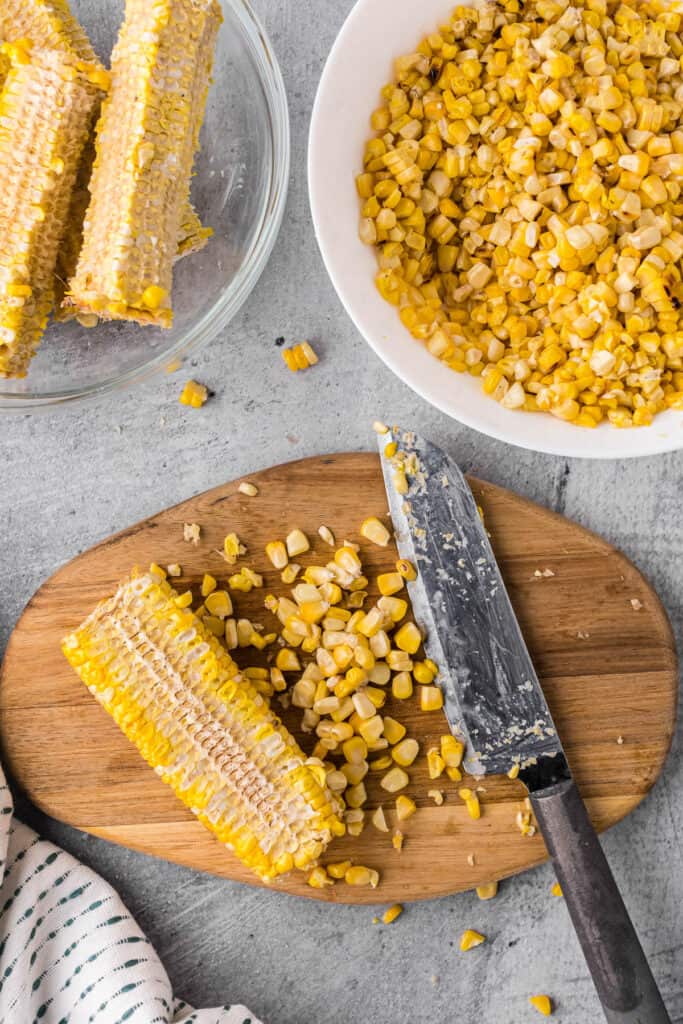 cutting corn kernels off roasted ears.