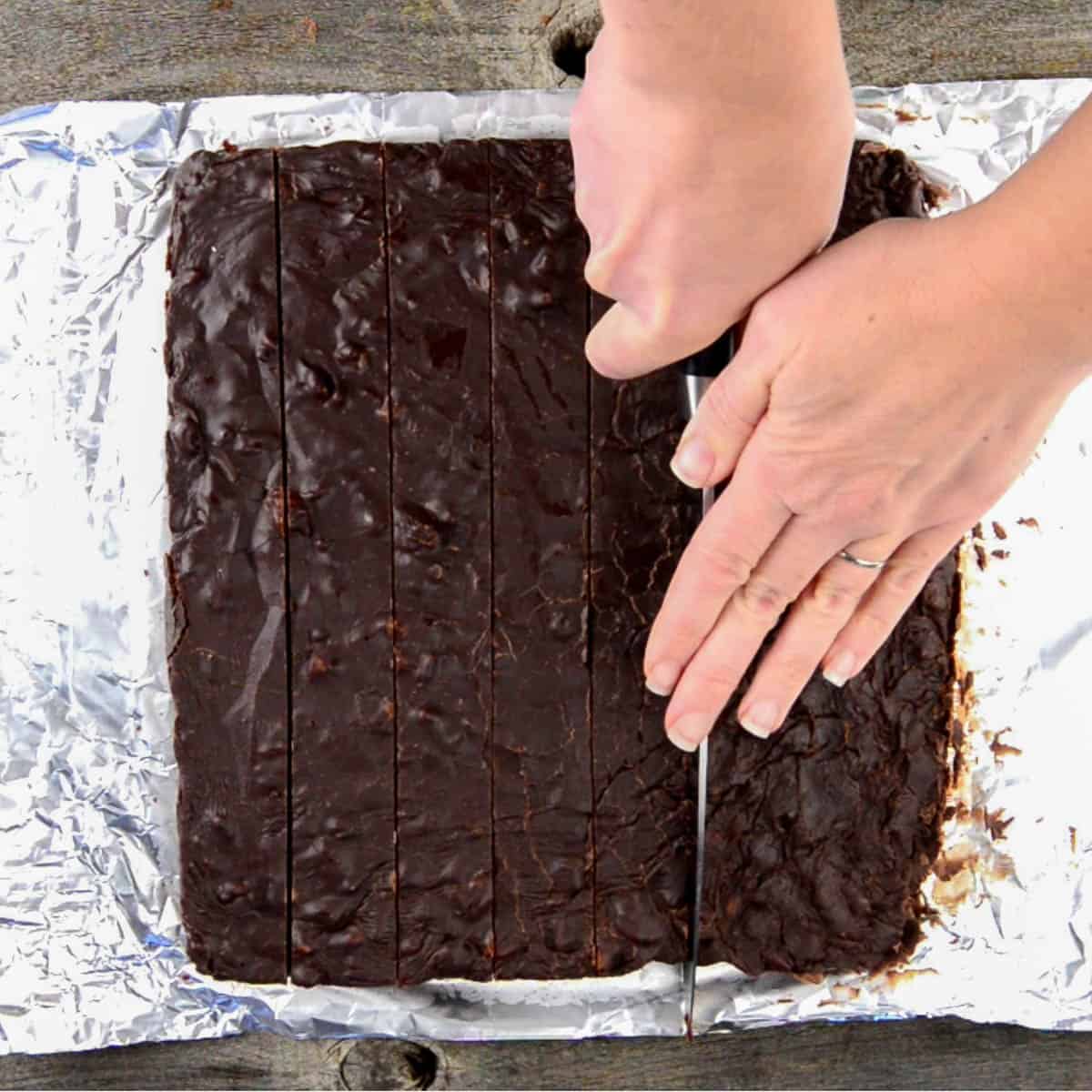 Cutting homemade chocolate fudge into squares.