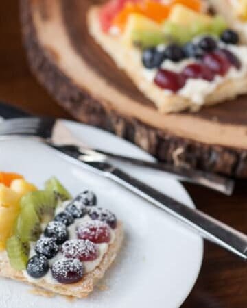 Mini Rainbow Fruit Pizzas transform flaky puff pastry, sweetened mascarpone, & fresh fruit into a colorful sweet treat perfect for breakfast or dessert.