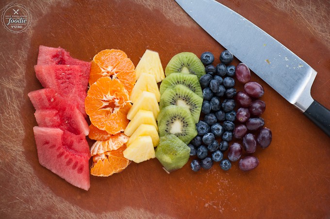 sliced fruit on cutting board in the color of the rainbow