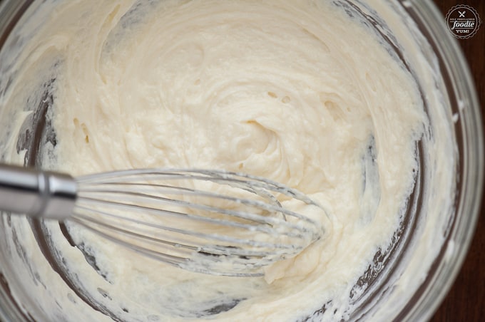 sweet cream cheese and mascarpone filling in bowl with whisk