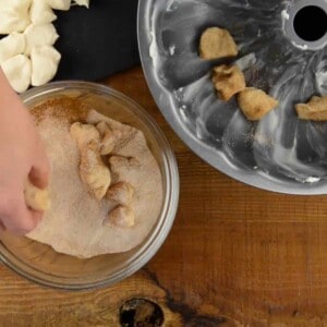 rolling biscuit dough in cinnamon and sugar