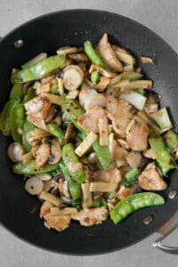 chicken with vegetables in wok pan