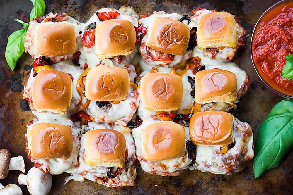 a dozen homemade mushroom ground beef sliders with sauce, peppers and cheese