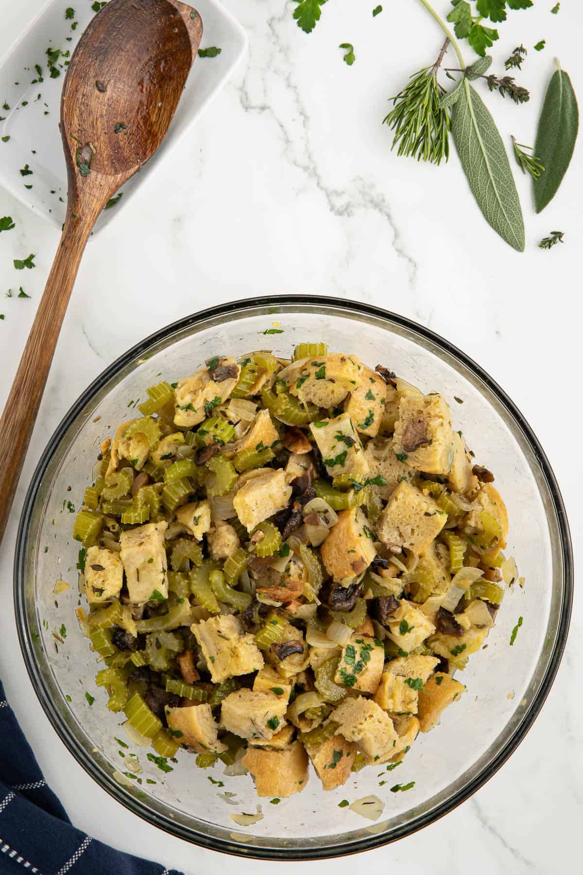 Mixing wild mushroom stuffing ingredients.