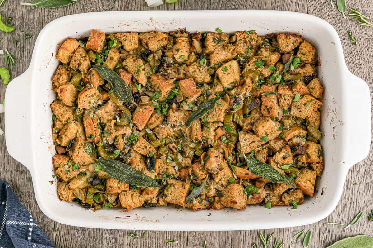 Thanksgiving wild mushroom stuffing in white casserole dish.
