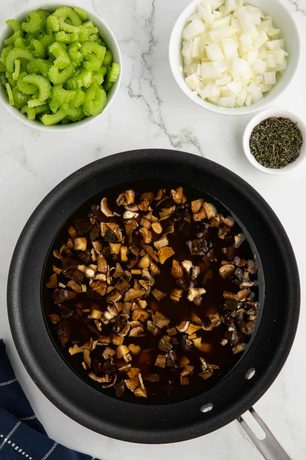 hydrating dried mushrooms in warm chicken broth.